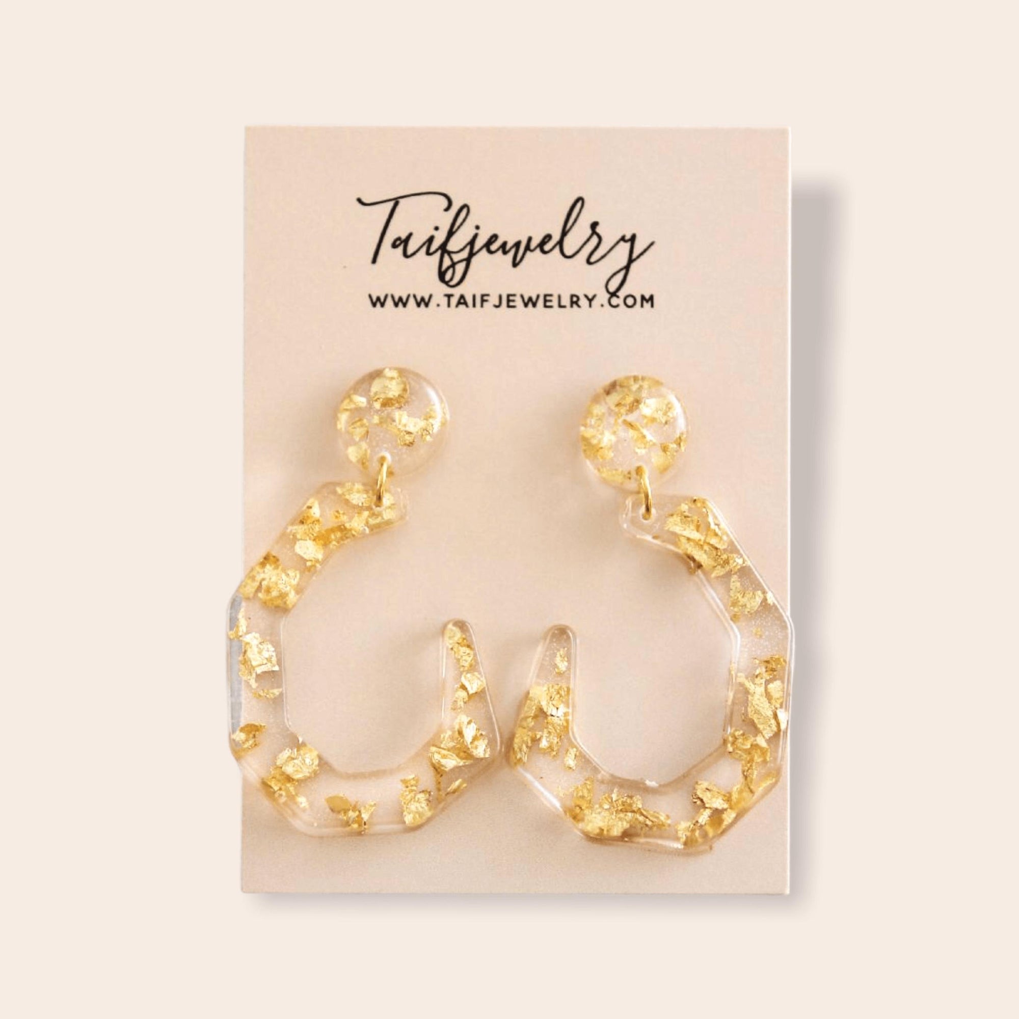 THE CLEAR GOLD-FLAKE RESIN EARRINGS .